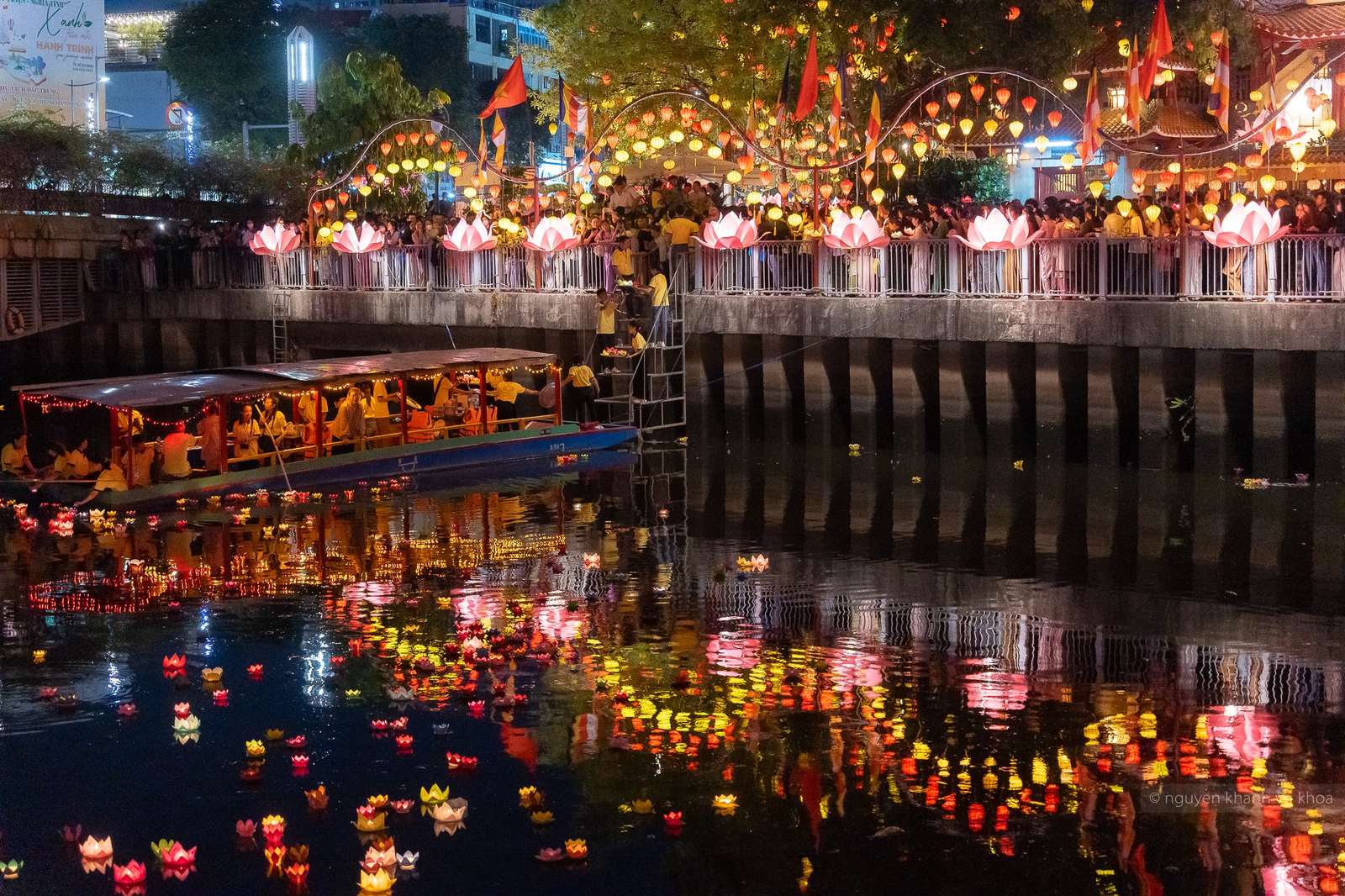 Flower lanterns floating on the water at Phap Hoa Pagoda during Vesak, Ho Chi Minh City